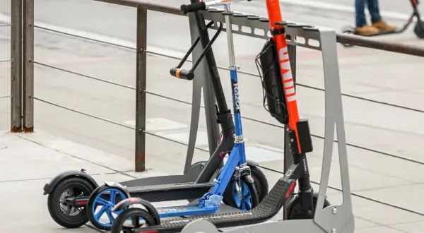 Trottinettes électriques garées, certaines avec un antivol. Une alarme trottinette électrique pourrait dissuader les voleurs.
